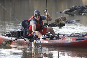 Net folded for compact storage in a kayak