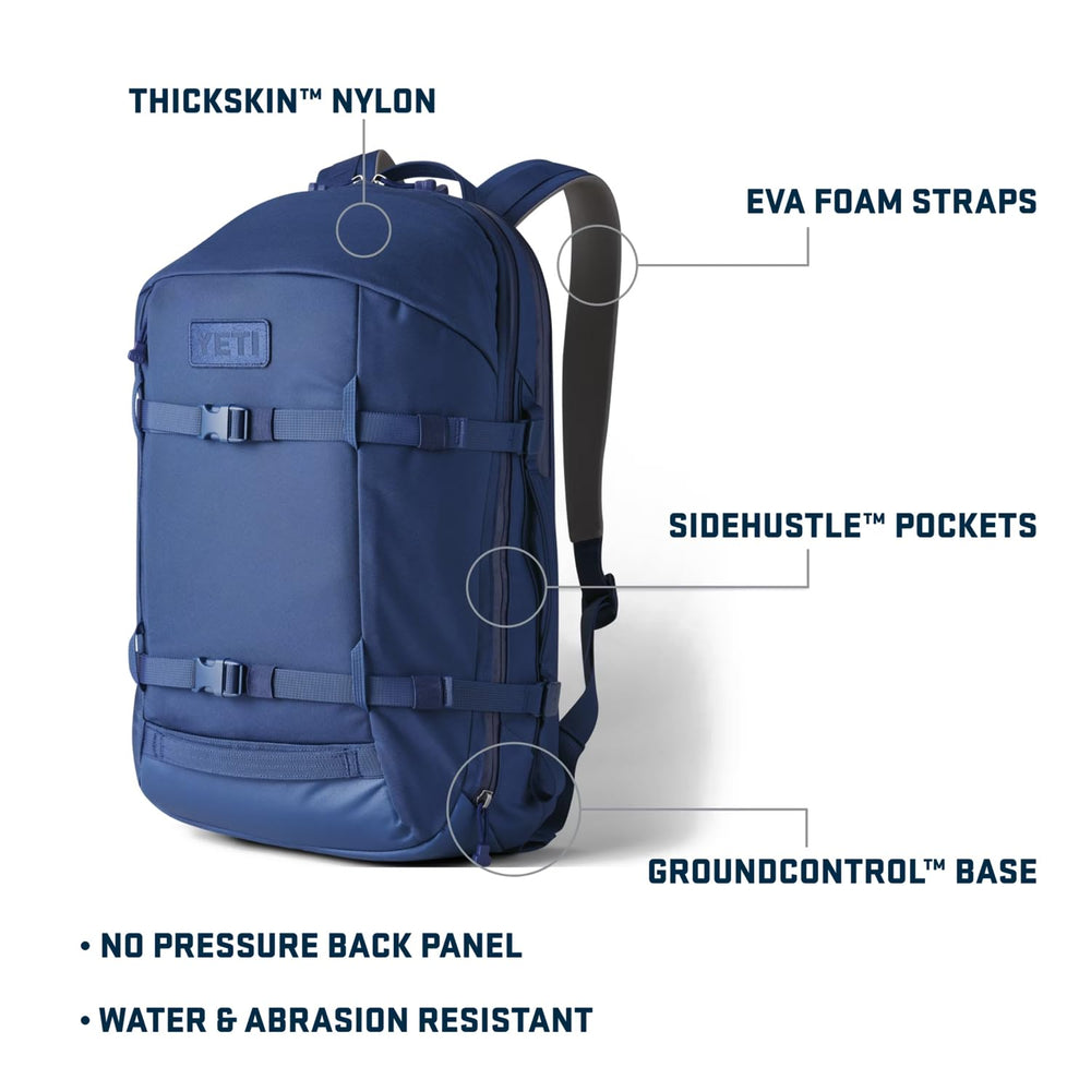 YETI Crossroads 27L backpack side pocket ultramarine violet supports quick-access hydration or snacks.