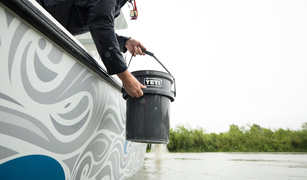 YETI LoadOut bucket at duck blind with spent shells.