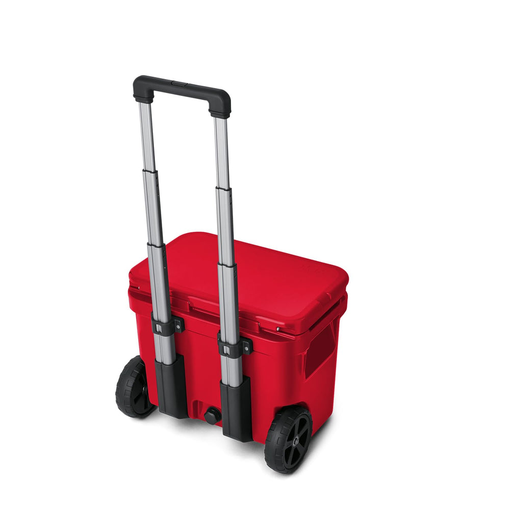YETI Roadie 32 wheeled cooler on tailgate setup for beverages and snacks.