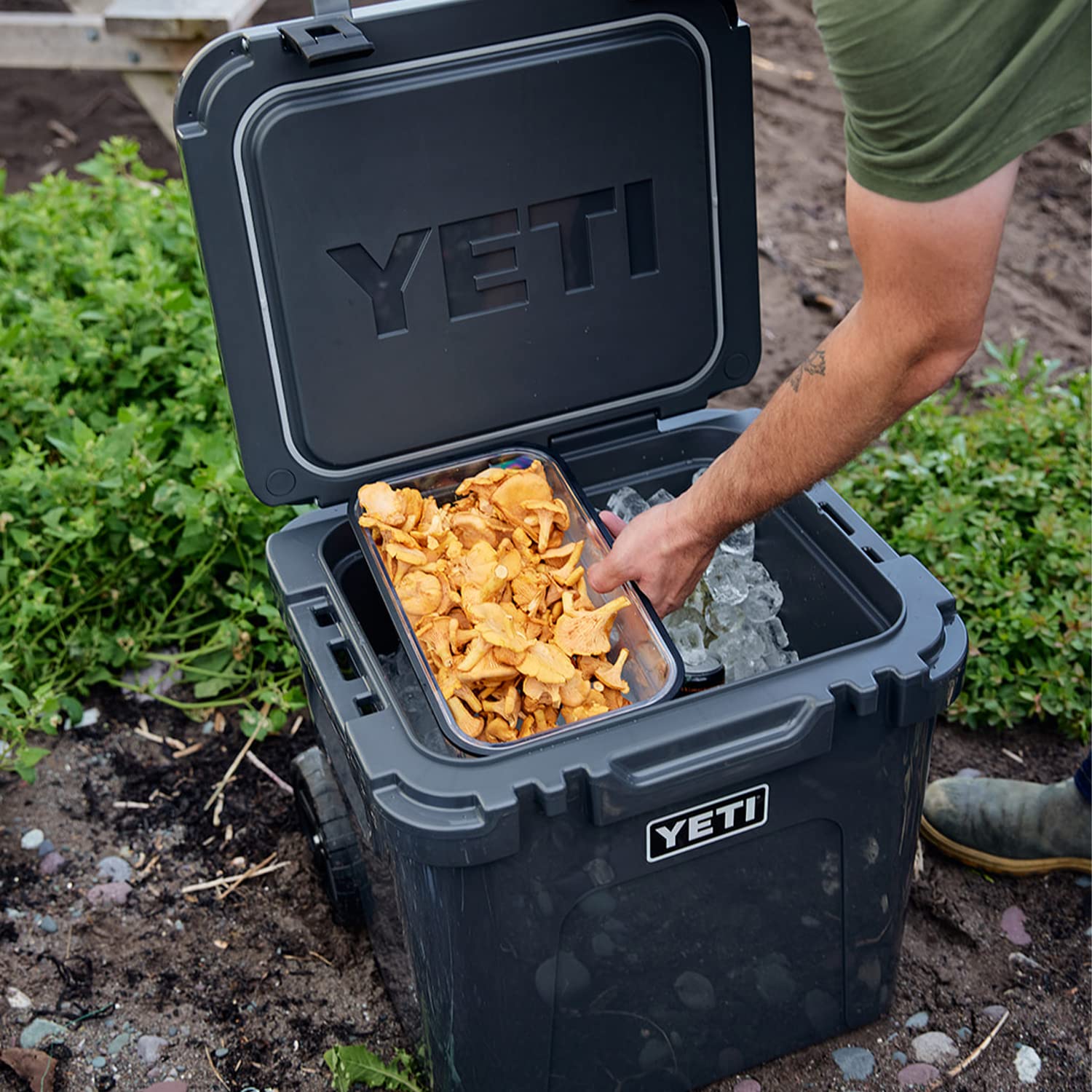 Roadie wheeled cooler holding two dry baskets for organized storage.