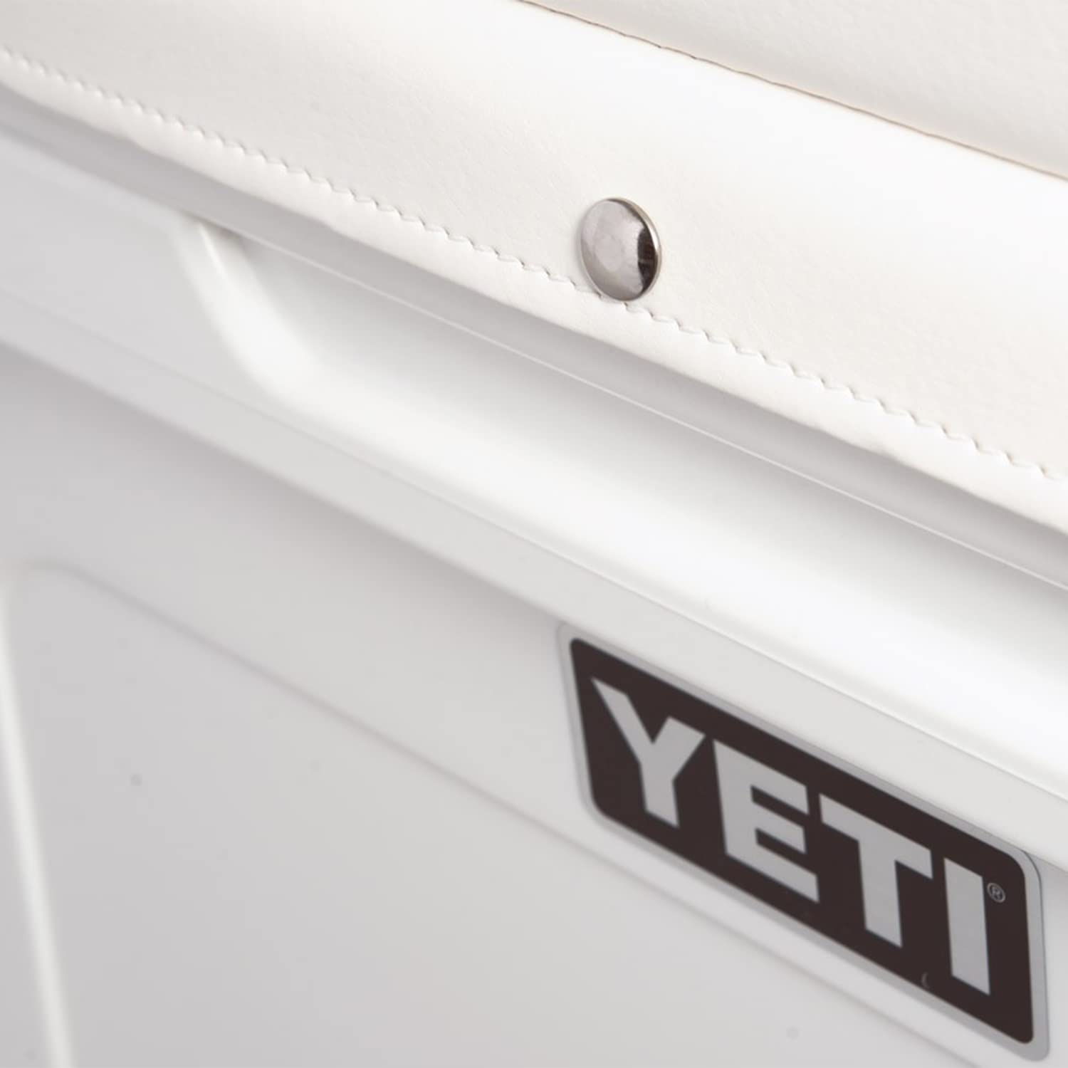 Stainless steel studs secure cushion to cooler lid on YETI