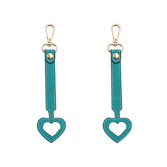 YEZILUU heart-shaped hat clip in dark blue vegan leather demonstrates secure hands-free storage.