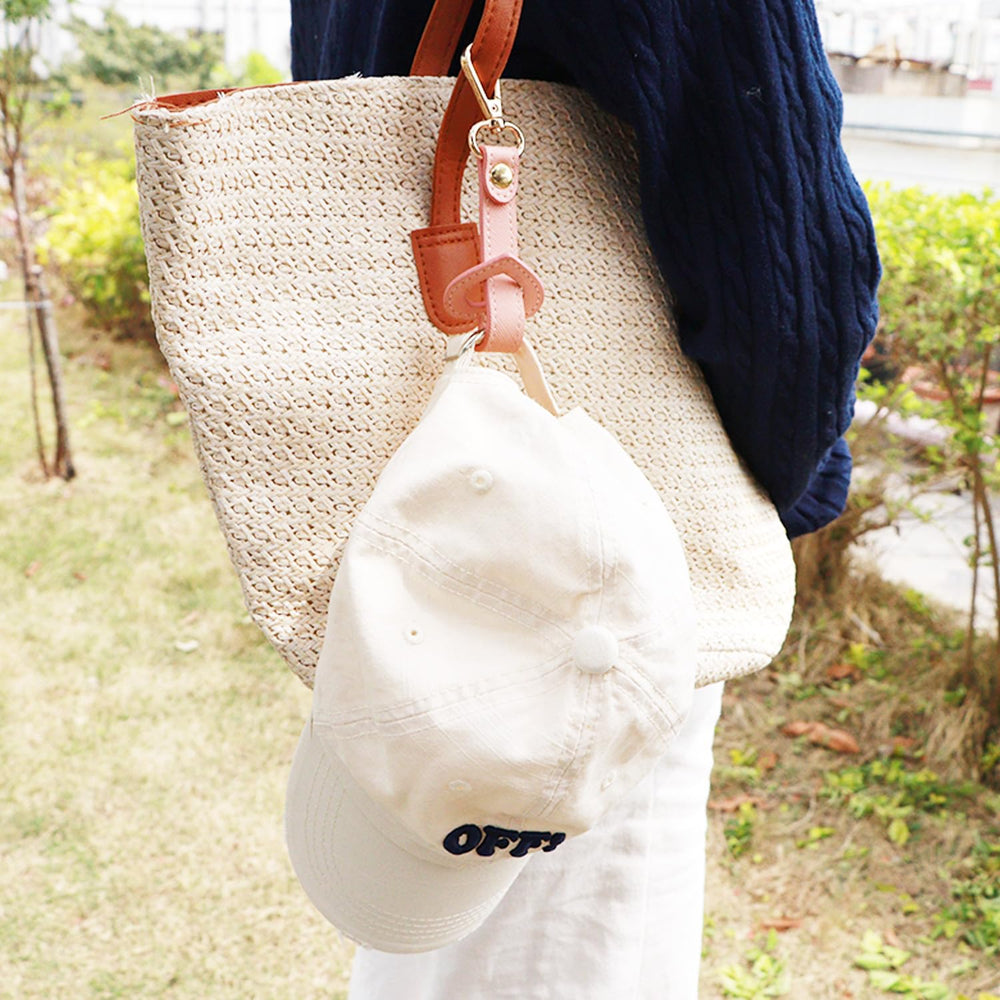 YEZILUU travel hat clip shown clipped to a bag for easy access