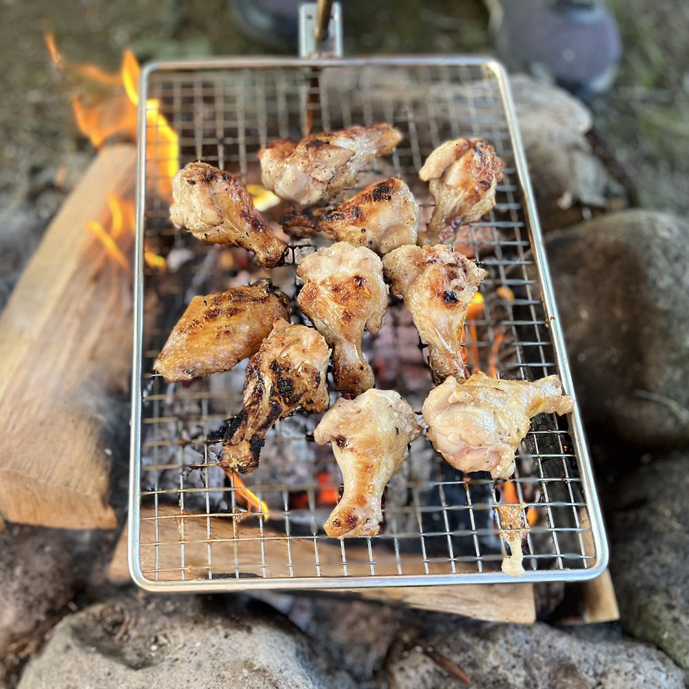 Zalderan Campfire Grill patented mesh close-up showing even cooking.
