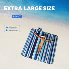 ZAZE beach blanket with stakes securing a stable setup in windy conditions.