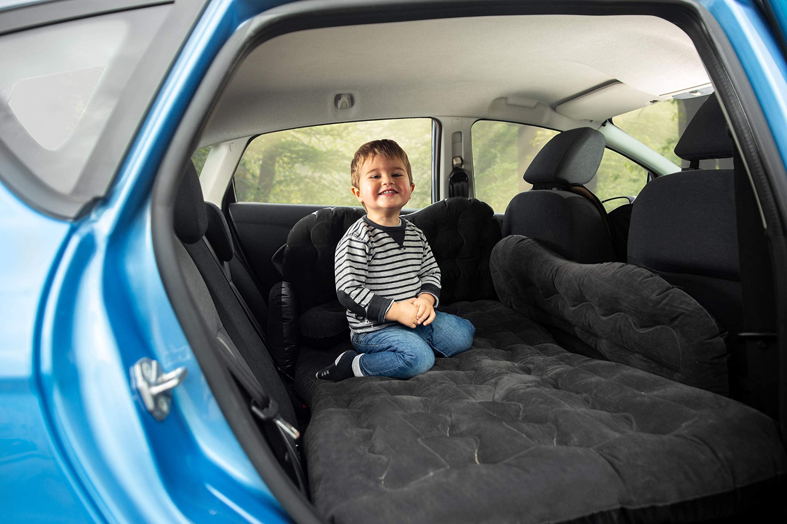 Zento Deals universal-fit mattress unfurls across SUV interior for camping use.