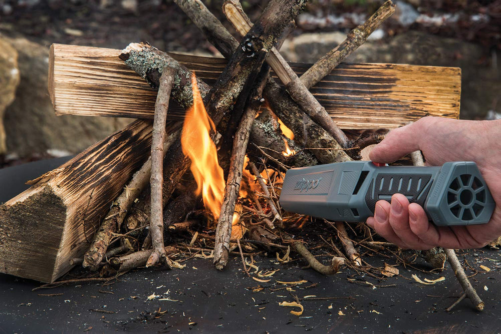 Zippo Firefast Bellows in use boosts campfire ambiance with controlled flames.